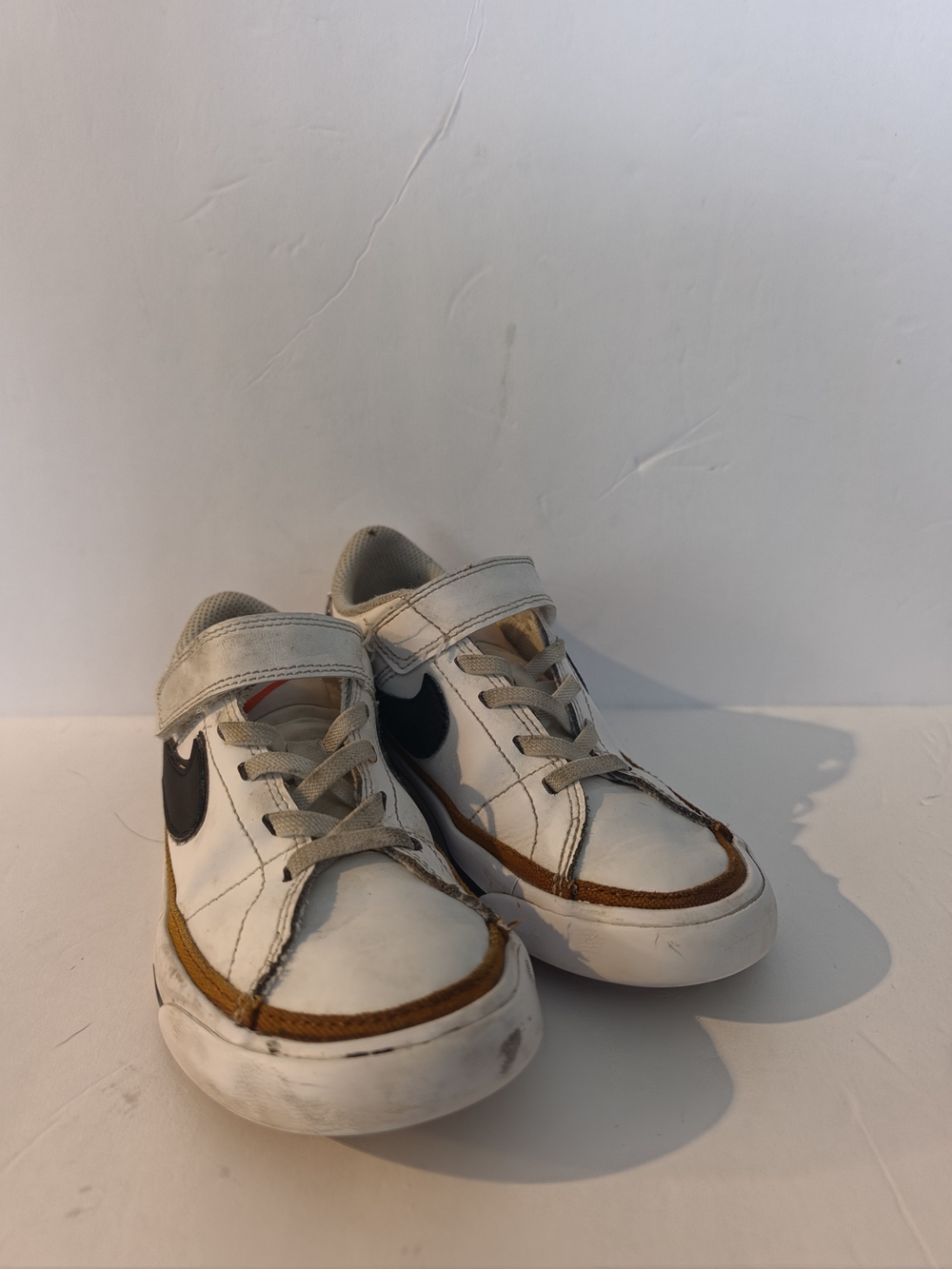 Nike White Kids Sneakers with Brown Trim and Black Swoosh